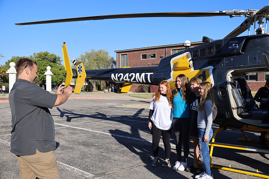 students in front of a emt helicopter