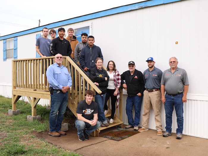 Cowley construction crew, instructors, and home owner on the newly built deck