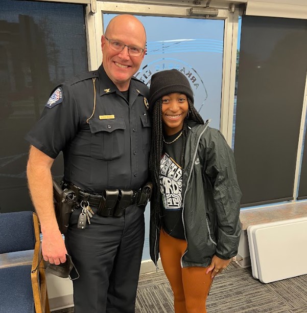 student with local police chieft