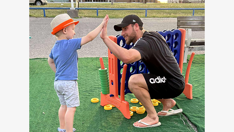 child high-fives a student athlete