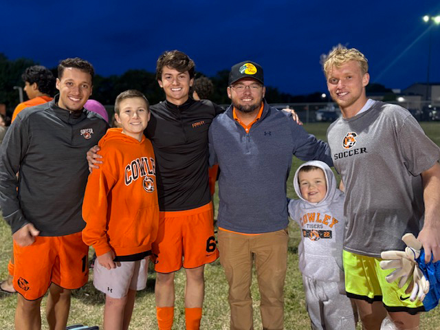 foster family with cowley college soccer players on the sideline