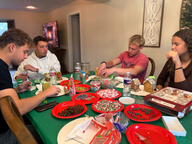 cowley college athletes making christmas treats with their foster family