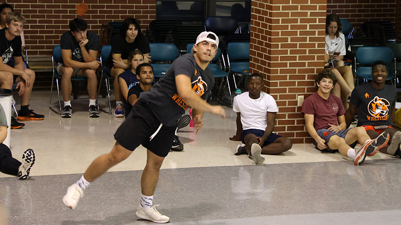 cowley college student serving a volleyball during intramurals