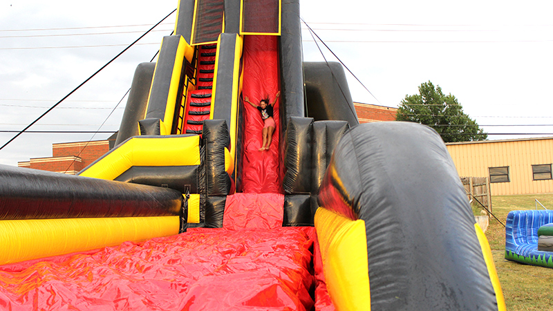 student on water slide at welcome week bash
