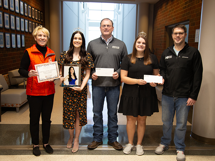 Kinzie Pappan and Emma Badley are presented with scholarships