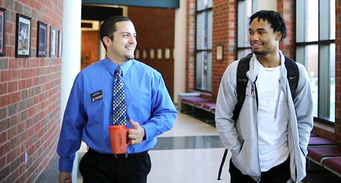 instructor with student in hallway