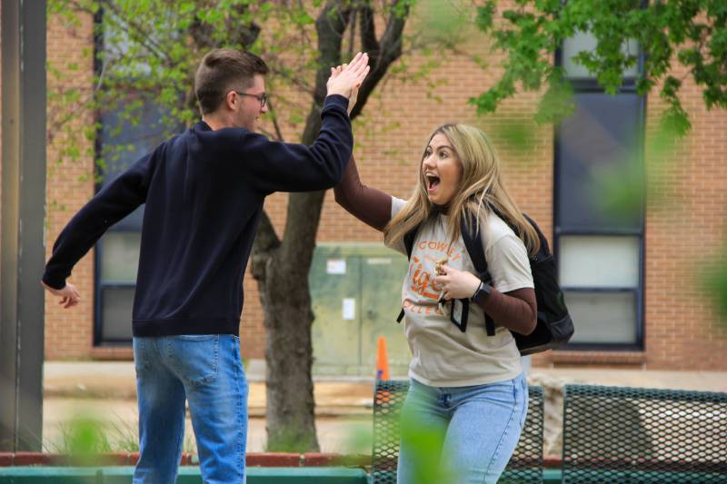 two students high fiving