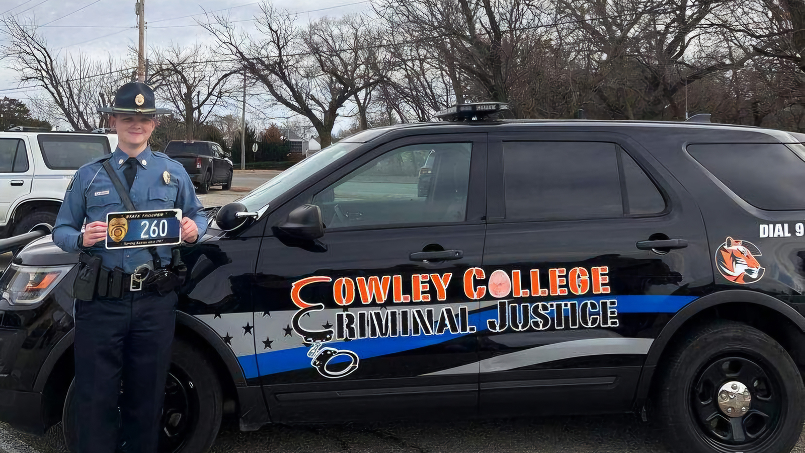 student in state officer uniform with license plate