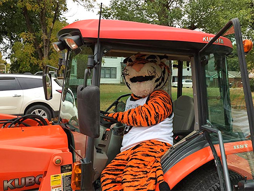 tank the tiger sitting on a tractor